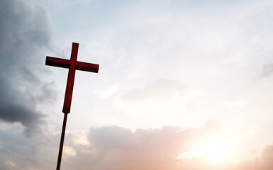 A christian cross under cloudy sky