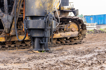 a pile driver or pile driver stands at a construction site for piling the foundation of a house