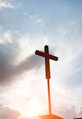 A christian cross under cloudy sky