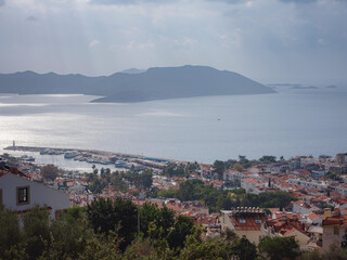 Harbour of city Kas or Kash in Turkey and Greek island Kastelorizo. Charming view of seaside resort town. Romantic harbour with yacht marina and mosque with minarets