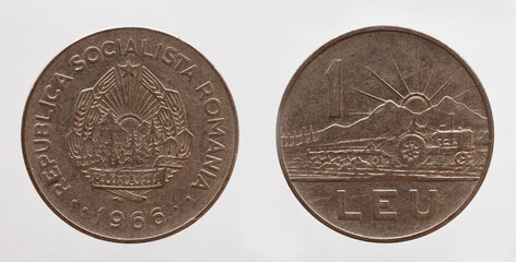 romania - circa 1966: a 1 leu coin of romania showing a landscape and a tractor with a plow working...