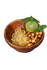 closeup the fried yellow gram split lentils with black gram and sliced lemon ,mint in the red wooden bowl over out of focus white background.