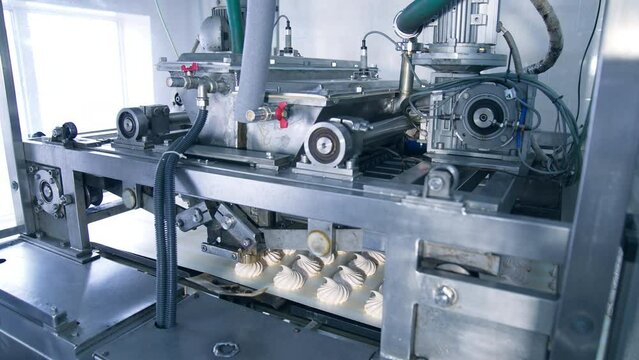 Automatic machine with complicated mechanism working and producing marshmallows. Equipment at modern food factory.