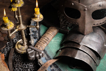 Medieval armor and sword on the table close up background.