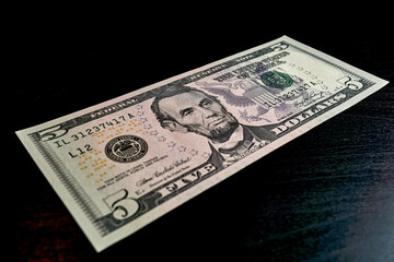 5 american dollar banknote on black table