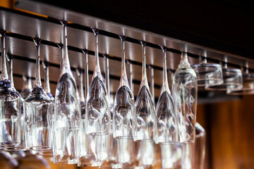 a large number of shiny glasses hanging from the ceiling in the restaurant