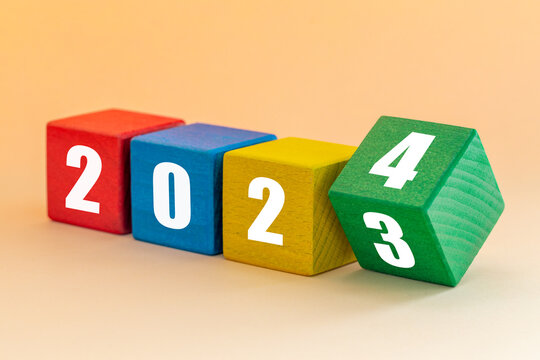 2023 to 2024, White numbers on joyfully colored blocks, Merry Christmas and a Happy New Year, Apricot background