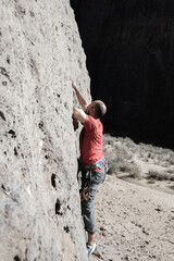 side view of man climbing on rock