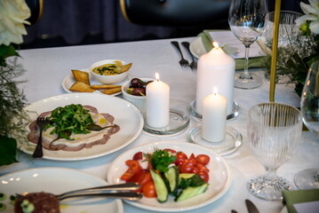 Wedding banquet. The festive table is served with plates with na