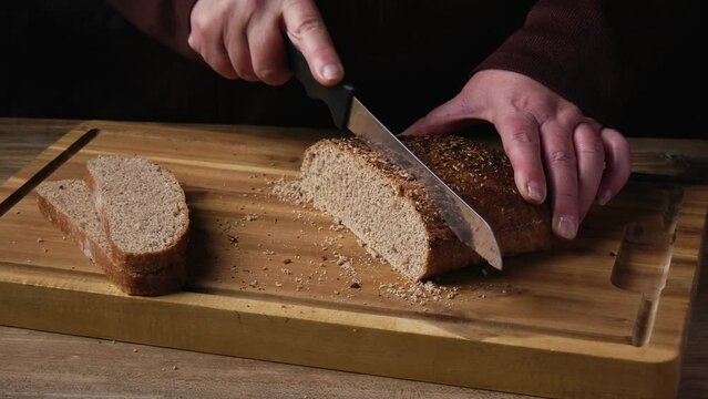 Cutting slices of wholemeal bread