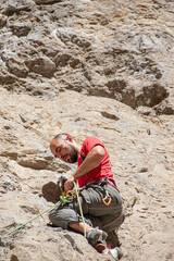 bottom view of man climbing on rock