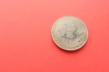 Bitcoin coin on a red background. Crypto currency and internet payment. Sanctions impact on the market.