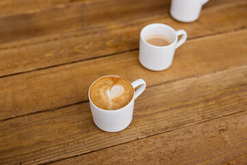Espresso coffee on a wooden table. Coffee in a small cup. Good morning. Small cups of coffee. Grain.