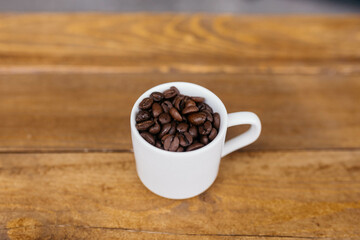 Espresso coffee on a wooden table. Coffee in a small cup. Good morning. Small cups of coffee. Grain.