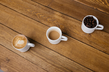 Espresso coffee on a wooden table. Coffee in a small cup. Good morning. Small cups of coffee. Grain.
