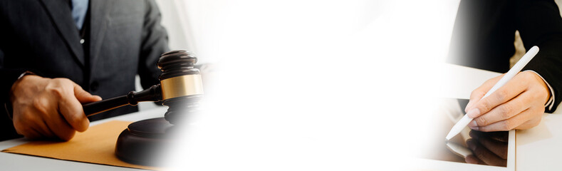 Judge gavel with Justice lawyers having team meeting at law firm in background. Concepts of law.