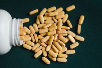 yellow oblong tablets are scattered over  dark green background