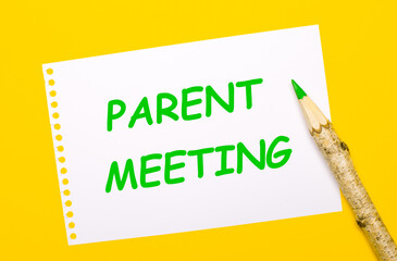 On a bright yellow background, a large wooden pencil and a white sheet of paper with the text PARENT MEETING