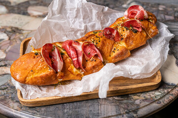 Typical serrano or iberian ham sandwich. Bocadillo de jamon. bellota ham. guijuelo, iberico. Traditional classic spanish restaurant or bar menu item.