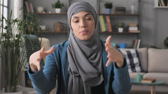 Muslim Female Business Woman Talking To The Camera In Video Call Online Meeting,arabian Woman Tutor Sits At The Desk Coaching During A Work Conference Briefing Front View