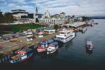 Panoramic view of Valdivia riverbank and marketplace ("Mercado Fluvial") with Calle-calle river with boats and ships, Chile