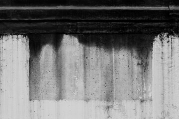 Black dirty spots of fuel oil flow liquid down spill the white old wall surface chemical industry streak background © Andrey