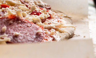 Raw pizza, preparation in traditional style. Raw pizza on baking paper