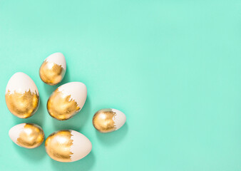Easter decoration. Golden Easter eggs turquoise background
