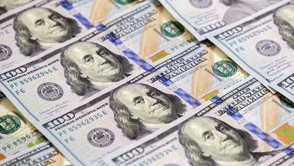 A sheet of new hundred dollar bills are laid out on the table, in a row and in a circle. Great...