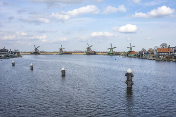 View of Zaanse Schans - museum village in Zaandam with Dutch houses and windmills. ZAANDAM, The NETHERLANDS. MARCH 12, 2022.