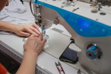 close-up of a female hands working with a sewing machine, closeup