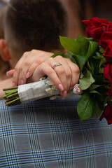 hands of woman wedding ring flower