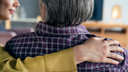 Comforting hand on shoulder of man	