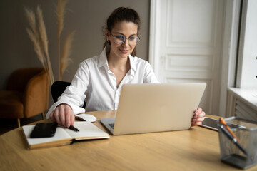 Freelancer with glasses woman working in office workplace monthly budget report, formal stylish clothes