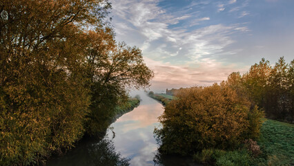 autumn trees reflected in water