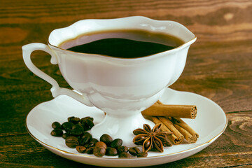 cup of coffee and anise on a wooden background