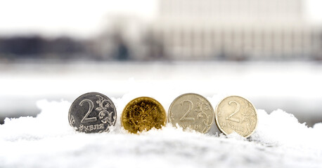 A coin worth two Russian rubles against the background of the government house in Moscow