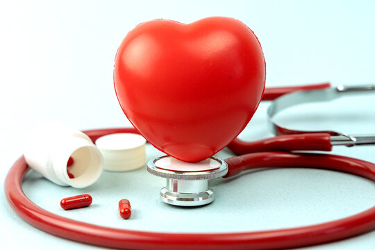 Red heart with stethoscope on white background