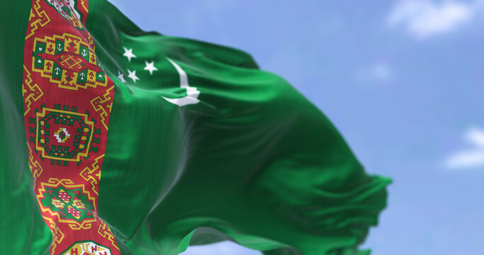 Detail of the national flag of Turkmenistan waving in the wind on a clear day