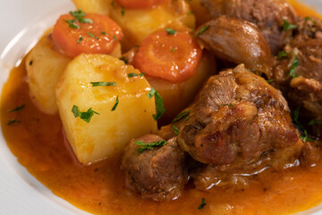 Navarin Lamb Shank Stew on wood table and and potatoes - Powered by Adobe