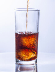 Glasses of cola with ice cubes served with a splash