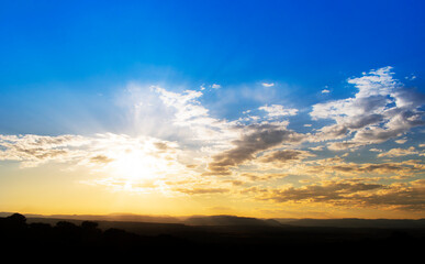 Beautiful sunset with blue and orange colors and sun rays