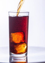 Glasses of cola with ice cubes served with a splash