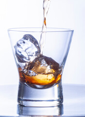 whiskey glasses with ice cubes on steel table