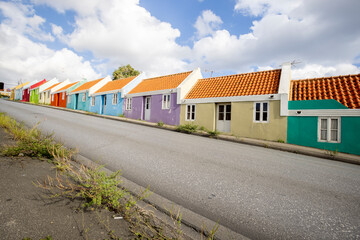 Fototapeta na wymiar Small colorful houses along the road somewhere in Willemstad, Curacao