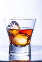 whiskey glasses with ice cubes on steel table