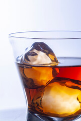 whiskey glasses with ice cubes on steel table