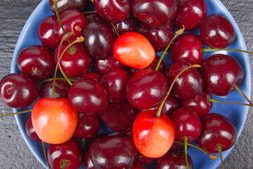 Various summer Fresh Cherry in a bowl on rustic wooden table. Antioxidants, detox diet, organic fruits. Berries. Berries