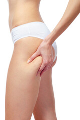 Young woman in underwear squeezing skin to show cellulite and stretch marks isolated on white background.