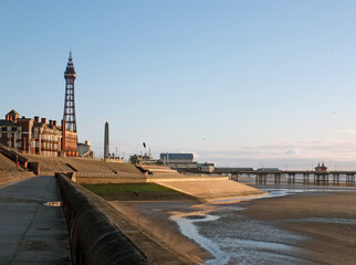 view of blackpool tower and south pier from the promenade with town buildings in afternoon sunlight © Philip J Openshaw 